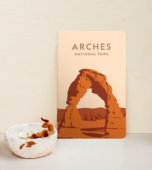 A notebook with Arches National Park illustrated on it.